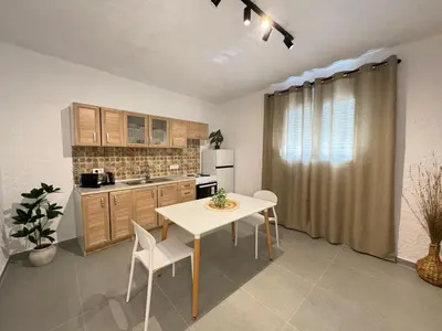 a kitchen with a table and a white table and chairs at LA Casa Di Lusso Casa N2 Adults Only in Kolimbia