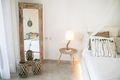 a bedroom with a mirror and a bed and a table at Marieta Suite in Vrachonisída touArchangélou