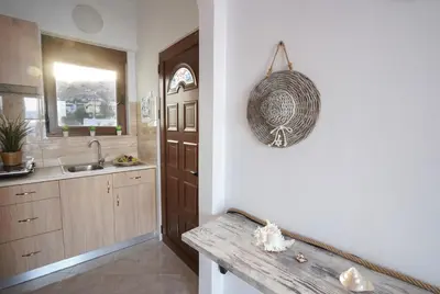 a kitchen with a counter and a sink and a mirror at Marieta Suite in Vrachonisída touArchangélou
