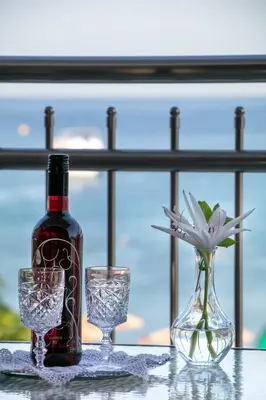 a bottle of wine and two glasses on a table at Marieta Suite in Vrachonisída touArchangélou