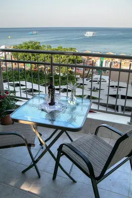 a table and chairs on a balcony with the ocean at Marieta Suite in Vrachonisída touArchangélou