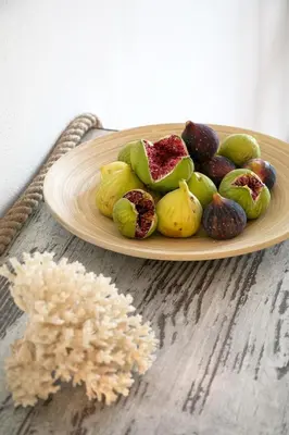 a plate of fruit on a table with rice at Marieta Suite in Vrachonisída touArchangélou