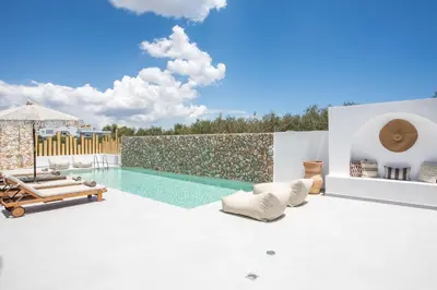 a villa with a swimming pool and a patio at Zaia Suites & Living, Suite N3, pool view, central in Gennadi