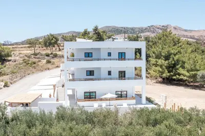 a white building on the side of a road at Zaia Suites & Living, Suite N3, pool view, central in Gennadi