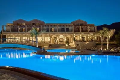 a hotel with two pools in front of a building at Lindian Dream Seaside Resort- Adults Only in Líndos