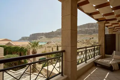 a balcony with a view of the ocean and mountains at Lindian Dream Seaside Resort- Adults Only in Líndos