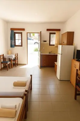 a large room with a kitchen and a refrigerator at Merryland Studios & Apartments in Kremasti