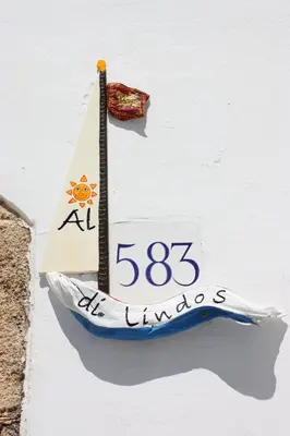 a paper boat on the side of a wall at Al 583 di Lindos in Líndos