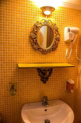 a bathroom with a mirror and a sink at Al 583 di Lindos in Líndos