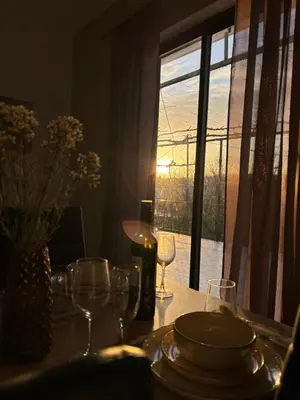 a table with wine glasses and a table with a window at V&G Cozy Home, Pilona Village in vlicha