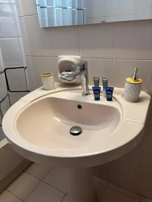 a bathroom sink with three cups and a faucet at V&G Cozy Home, Pilona Village in vlicha