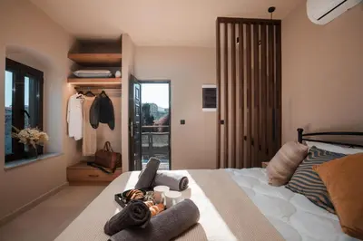 a bedroom with a bed with towels on it at Villa il Borgο in Rhodes Town