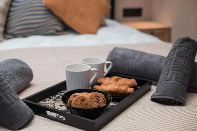 a tray of food and cookies on a bed at Villa il Borgο in Rhodes Town