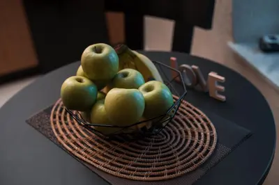 a bowl of apples and bananas on a table at Villa il Borgο in Rhodes Town