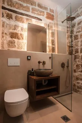 a bathroom with a sink and a toilet and a mirror at Villa il Borgο in Rhodes Town