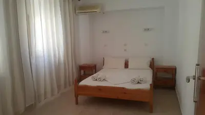 a bedroom with a bed with two towels on it at Lindos Center Studios in Líndos