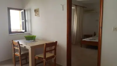a room with a table and chairs and a window at Lindos Center Studios in Líndos