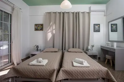 a bedroom with two beds with towels on them at Malibu Villa in Kremasti