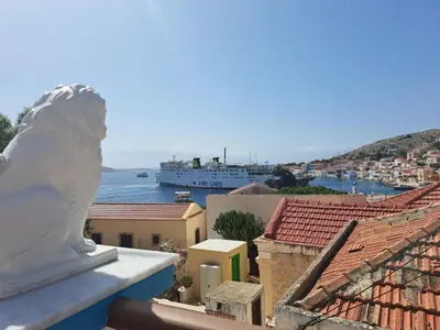 a statue of a lion sitting on top of a building at Villa Efraim Amalia in Halki