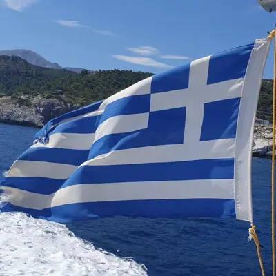 a blue and white flag on the side of a boat at Villa Efraim Amalia in Halki