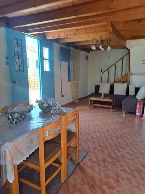 a living room with a table and a couch at Villa Efraim Amalia in Halki