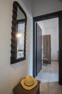 a hat sitting on a table in a room with a mirror at Ixia del Mar Apartment in Ixia