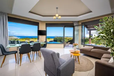 a living room with a view of the ocean at Aqua Natura Villas in Lachania