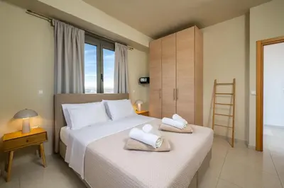 a bedroom with two beds with towels on them at Aqua Natura Villas in Lachania