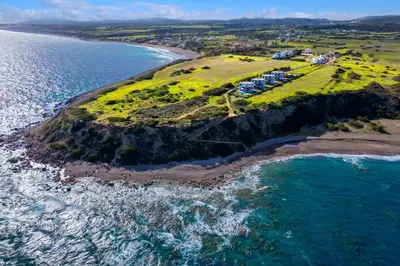 an aerial view of an island with houses and the ocean at Aqua Natura Villas in Lachania
