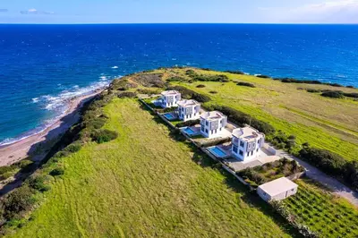 an aerial view of an island with white houses at Aqua Natura Villas in Lachania