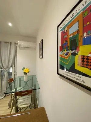 a dining room with a glass table and a painting on the wall at Melograno di Rodi 8 in Rhodes Town