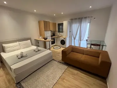 a bedroom with a bed and a couch and a kitchen at Melograno di Rodi 8 in Rhodes Town