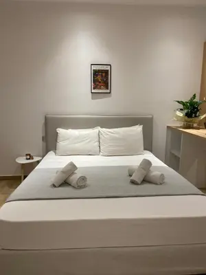 a bed with two pillows on top of it at Melograno di Rodi 8 in Rhodes Town