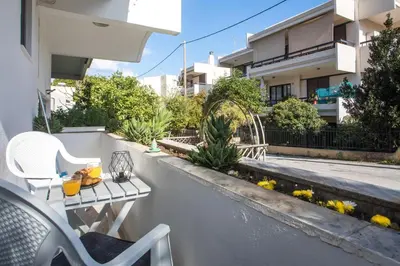 a balcony with a table and chairs on a building at Ixia del sol Apartment in Ixia