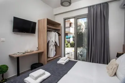 a bedroom with a bed and a tv and a window at Ixia del sol Apartment in Ixia
