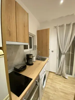 a kitchen with wooden cabinets and a counter top at Melograno di Rodi 9 in Rhodes Town