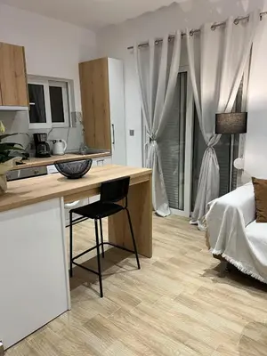a kitchen with a desk and a bed in a room at Melograno di Rodi 9 in Rhodes Town