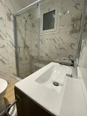 a white bathroom with a sink and a mirror at Melograno di Rodi 9 in Rhodes Town