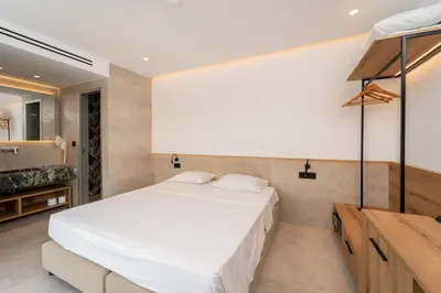 a bedroom with a large white bed in a room at Paloma Seaesta Cabanas in Rhodes Town