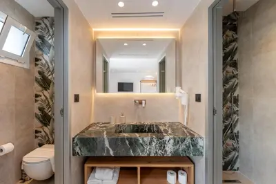 a bathroom with a sink and a toilet at Paloma Seaesta Cabanas in Rhodes Town