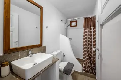 a bathroom with a sink and a mirror and a toilet at Lemonitissa Villa in Symi