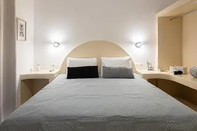 a bedroom with a large bed with two pillows at Gaia Rooms in Vrachonisída touArchangélou