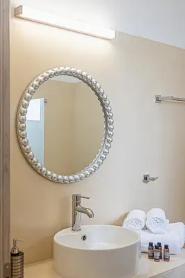a bathroom with a sink and a mirror at Gaia Rooms in Vrachonisída touArchangélou