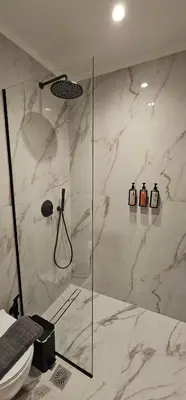 a bathroom with a glass shower with a toilet at S & E luxury city residences in Rhodes Town