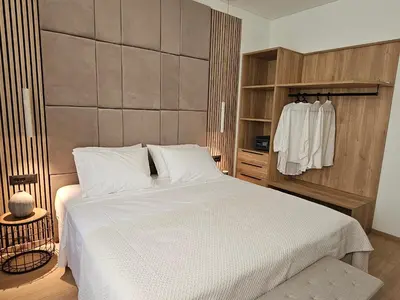 a bedroom with a large white bed and a closet at S & E luxury city residences in Rhodes Town