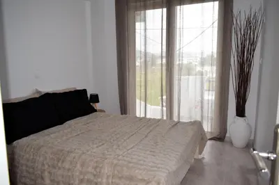a bedroom with a bed and a large window at Eraya Apartment in Haraki