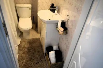 a bathroom with a toilet and a sink at Eraya Apartment in Haraki