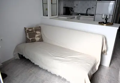 a white bench in a kitchen with a sink at Eraya Apartment in Haraki