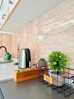 a kitchen with a counter with a tv on a counter at Marine's apartments in Symi