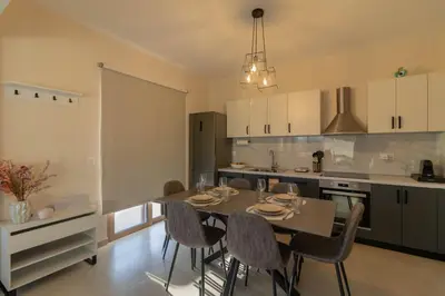 a kitchen with a table and chairs in a room at Kolymbia Bella View House in Kolimbia